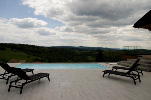 a patio with two chairs and a swimming pool at Skalna Osada in Istebna