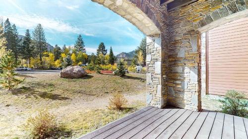 an outside door of a brick building with a yard at Cozy Cabin for 8 Close to Eagle Lodge in Mammoth Lakes