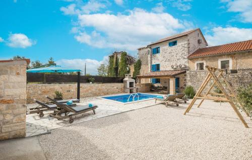 a patio with a swimming pool and a house at Cassa Antica with outdoor pool, near Poreč in Rapavel