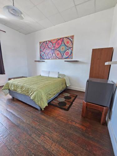 a bedroom with a bed and a flat screen tv at Holistic Scandinavia House in Arequipa