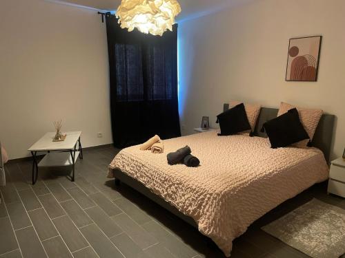 a bedroom with a bed with a teddy bear on it at les bambous in Mas-Saintes-Puelles
