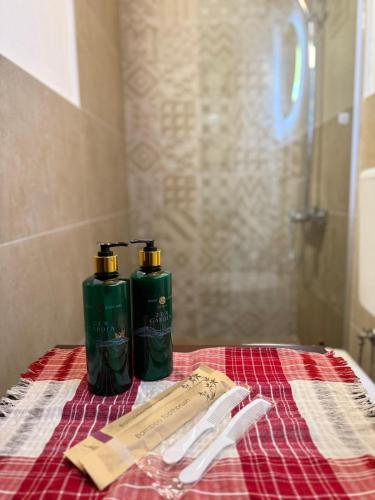 two green bottles sitting on top of a towel at Shasi Eco Lodge in Ambula