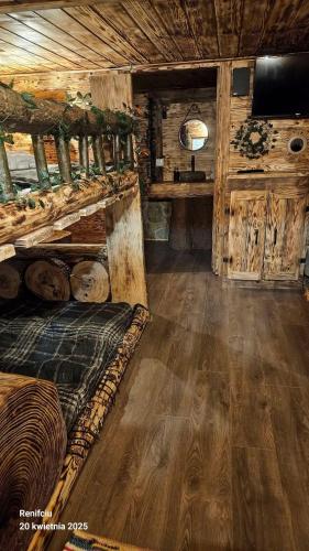 a room with a bed in a wooden cabin at Mała Bawaria in Zakopane