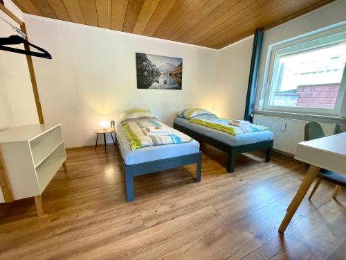 a room with two beds and a window at FeWo 2 - Rödental-Apartments in Rödental