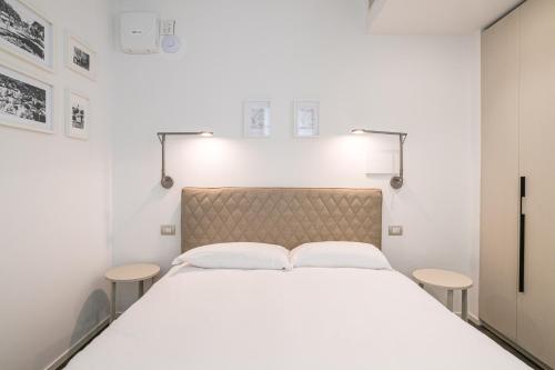 a bedroom with a large bed with two tables at Palazzo La Cortesella - Modern Design & Central Location in Como