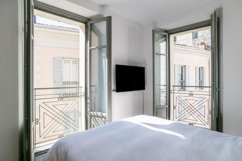 a bedroom with a bed and a large window at Palazzo La Cortesella - Modern Design & Central Location in Como