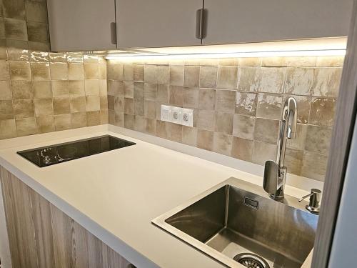 a kitchen counter with a sink and a sink at Casas Rurales Los Molinos in Sanlúcar de Guadiana