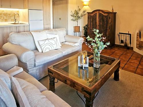 a living room with a couch and a coffee table at Casas Rurales Los Molinos in Sanlúcar de Guadiana