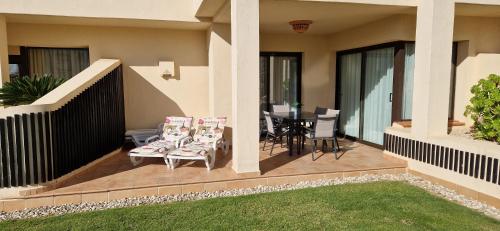 a patio with chairs and a table on a house at Casa Colina Roda Golf in San Javier