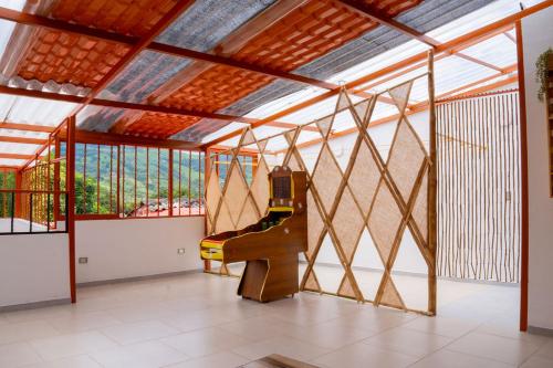a living room with a large window and a machine at Hospédate en Oiba con estilo WIFI TERRAZA in Oiba