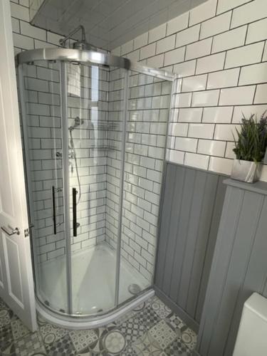a shower with a glass door in a bathroom at Rothesay, Isle of Bute in Rothesay