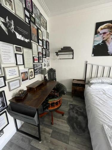 a bedroom with a desk and pictures on the wall at Rothesay, Isle of Bute in Rothesay