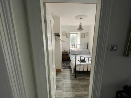 a hallway leading to a bedroom with a bed in a room at Rothesay, Isle of Bute in Rothesay