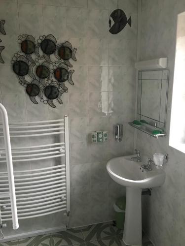 a bathroom with a sink and a shower at Smithy lodge Guest House in Leyland