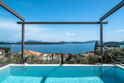 a view of the water from a house with a swimming pool at Villa Scorpios View in Nydri