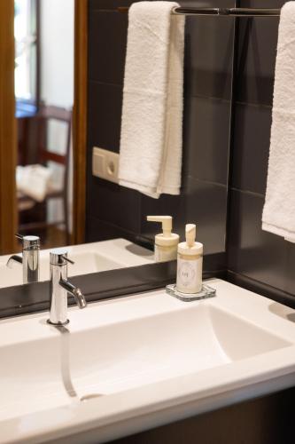 a bathroom with a white sink and a mirror at Quinta da Estivada in Gondomar