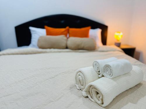 a bed with towels and pillows on it at DANK Hotel 420 friendly in Patong Beach