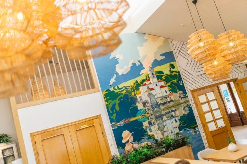 a dining room with a mural on the wall at Apartamentos Albatros in Barro de Llanes