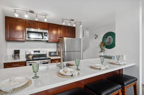 a kitchen with a counter with two plates on it at Just Steps to Beach with 2 King Beds and Centrally Located in Kihei