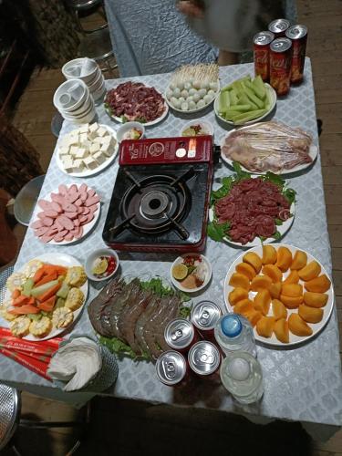 a table filled with different types of food at Moc's House bắc hà in Bắc Hà