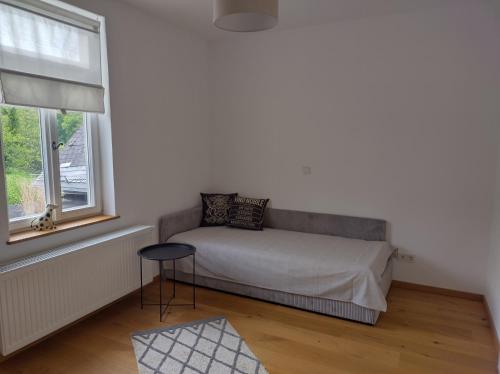 WeilrodにあるEtzauer Mühle im Taunus, Apartment mit Balkonのベッドと窓のある小さな寝室