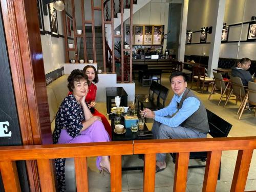 a group of people sitting at a table in a restaurant at Moc's House bắc hà in Bắc Hà