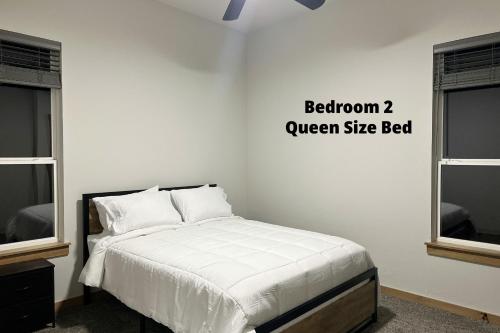 a bed in a room with a white wall at New Bison Cabin Hot Tub Air Hockey Pool Table in Purcell