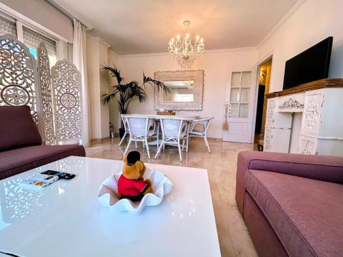 a teddy bear sitting in a chair on a table in a living room at Cisneros Royal in La Zubia