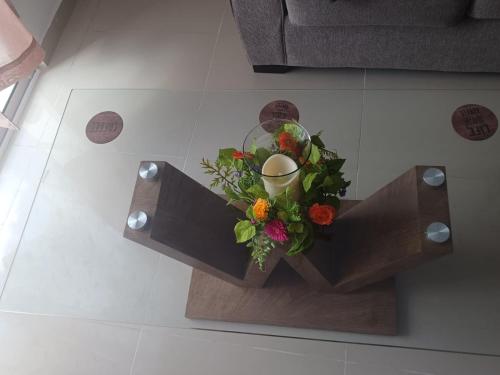 a table with a bouquet of flowers on it at Chelsie 402 in Bayahibe