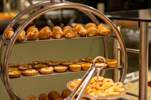 a bunch of donuts on shelves in a bakery at Del Rey Quality Hotel in Foz do Iguaçu