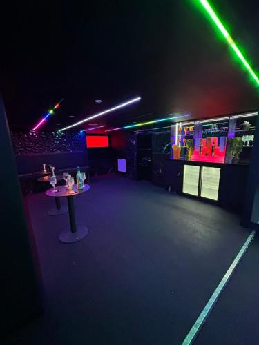 a dark room with a table and lights in it at New - The Fun House Blackpool - Private nightclub in Blackpool