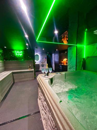a hot tub with green lights in a room at New - The Fun House Blackpool - Private nightclub in Blackpool