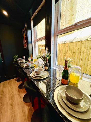 a table with plates and glasses and a bottle of wine at New - The Fun House Blackpool - Private nightclub in Blackpool
