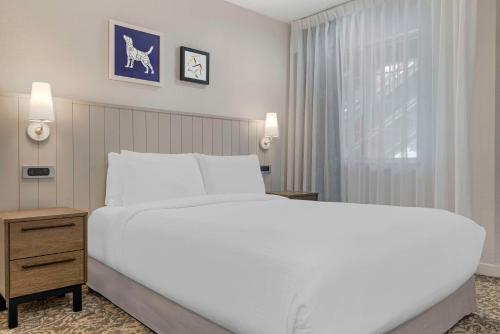 a bedroom with a large white bed and a window at Sonesta ES Suites Torrance Redondo Beach in Torrance