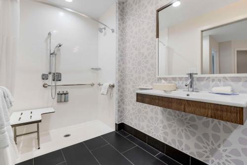 a bathroom with a tub and a sink and a shower at Sonesta ES Suites Torrance Redondo Beach in Torrance