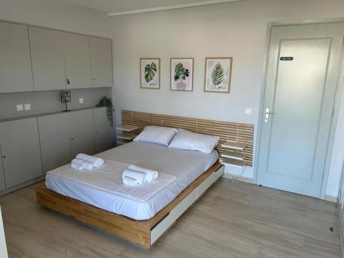 a bedroom with a bed with towels on it at Athens Riviera, Modern Vouliagmeni Flat at Cape of Lemos in Athens