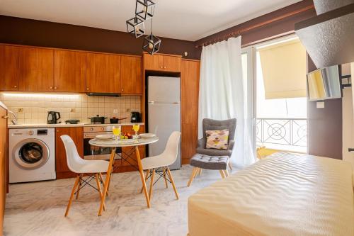 a kitchen with a table and chairs in a room at "La Vie Est Belle" by the sea Rethymno in Rethymno