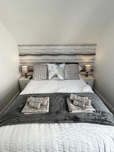 a bedroom with a large bed with two pillows on it at New - The Fun House Blackpool - Private nightclub in Blackpool