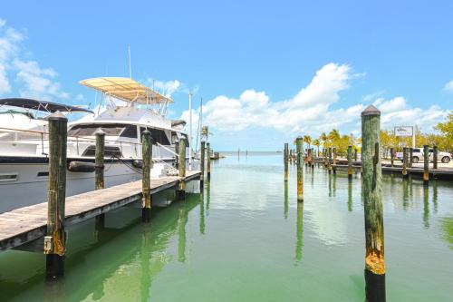 a boat docked at a dock in the water at 2 Mi to Sombrero Beach Condo with Pool and Hot Tub in Marathon