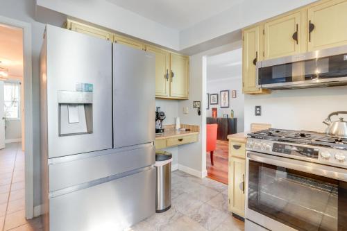 a kitchen with stainless steel appliances and wooden cabinets at 4 Mi to Stone Mountain Retreat with Office! in Stone Mountain