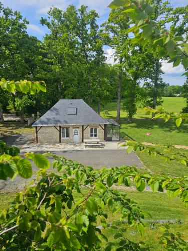 une petite maison au milieu d'un champ dans l'établissement Gîte le bûcher du château, à Barbeville