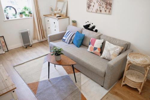 a living room with a couch and a table at Cozy 2-Bedroom Detached Home No-7 in Dublin