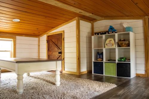 a room with a ping pong table in a house at Charming Cabin with Pond View and Private Hot tub in Carthage