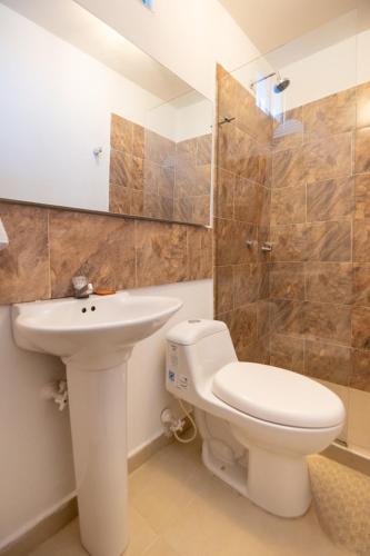 a bathroom with a toilet and a sink at Hotel Boutique Casa Pere in Cartagena de Indias