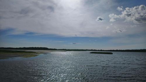a large body of water under a cloudy sky at Bayfront & nature preserve! in Riverhead
