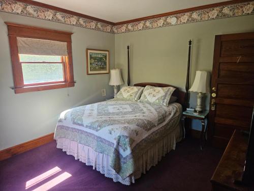 a bedroom with a bed and a window at Inn of Saugatuck in Saugatuck