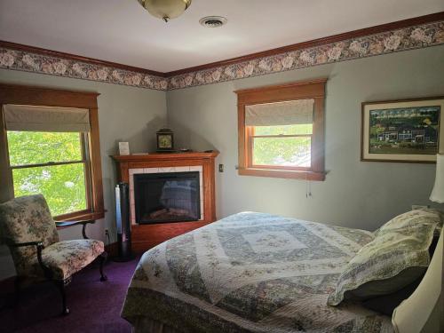 a bedroom with a bed and a fireplace at Inn of Saugatuck in Saugatuck