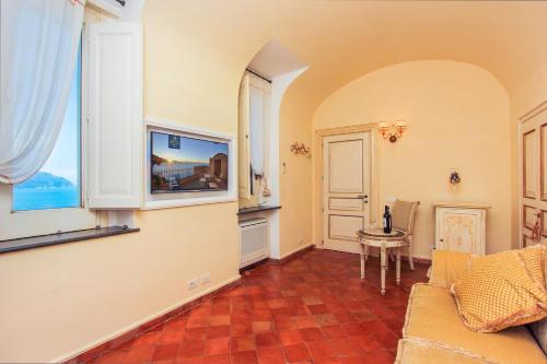 a living room with a couch and a table at Villa Alba d'Oro - Historic luxury villa in Amalfi