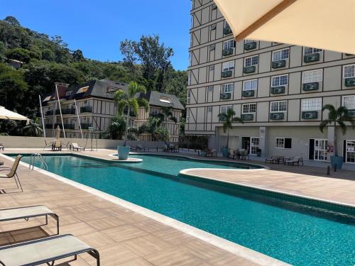 ein Schwimmbad vor einem Gebäude in der Unterkunft Flat em Itaipava! in Araras Petropolis