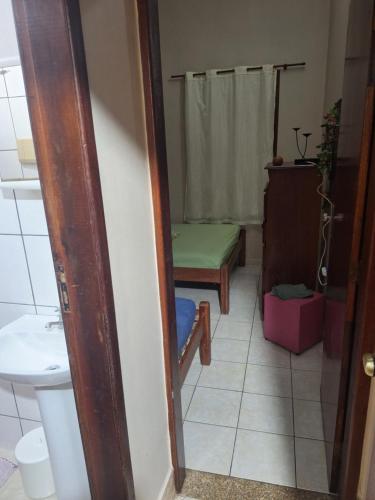 a small bathroom with a bench and a toilet at Casa Serra Macaé in Água Boa